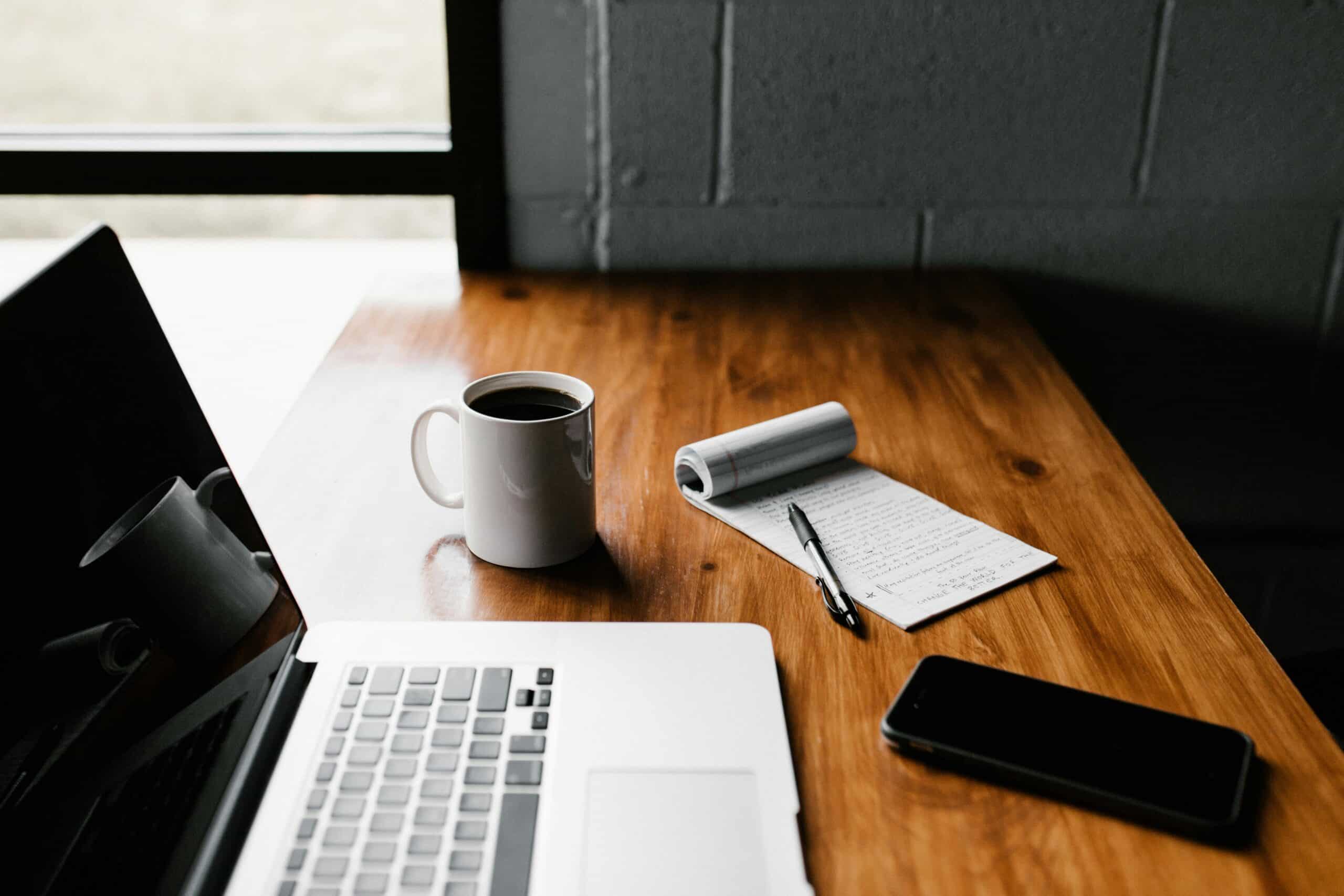 An image of a MacBook and iPhone, both of which can be used to send faxes.