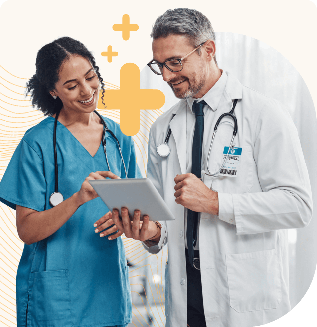 A male doctor and a female nurse looking at a tablet